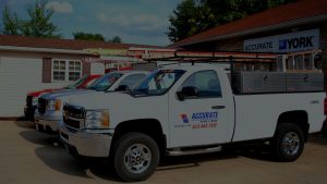 Accurate Heating & Cooling's trucks outside of their storefront in Columbia, Mo. Call us today for your HVAC installation and maintenance needs!
